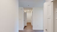 This single-floor, 2-bedroom, 2-bathroom residence in Athens, Alabama offers a thoughtfully designed layout that maximizes comfort and functionality. The interior is finished with a clean, contemporary aesthetic, featuring crisp white walls, wood-look plank flooring in key living areas, and plush carpet in the bedrooms.

The kitchen is a standout feature, equipped with stainless steel appliances including an electric range, microwave, and dishwasher. White shaker-style cabinetry, light quartz-style countertops, a deep stainless steel sink, and pendant lighting give the kitchen a modern, polished look.

The living room is carpeted and features a ceiling fan and a sliding glass door that fills the space with natural light and provides outdoor access. Both bedrooms are well-sized, with the primary bedroom offering a ceiling fan, natural light from a window, and a spacious closet fitted with wire shelving systems for organized storage.

The two bathrooms are finished with wood-look flooring, white cabinetry, and gray countertops. One bathroom features a tub-shower combo, while the other includes a walk-in shower and a backlit vanity mirror. A central hallway connects the private areas of the home, complemented by a welcoming entrance and additional closet storage throughout.