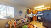 This 1-bedroom, 1-bathroom unit is thoughtfully designed to maximize both function and comfort across a single level. The open-concept layout seamlessly connects the living area to the kitchen, creating an inviting and efficient flow. The living room features warm wood-style flooring, a bright window with blinds that allows natural light to fill the space, and a welcoming entry with a smart lock door. The kitchen is well-equipped with warm honey-toned cabinetry, granite-style countertops, and a full suite of black appliances including a range, over-the-range microwave, dishwasher, and refrigerator — providing everything needed for everyday cooking. The bedroom offers a comfortable, private retreat with the same wood-style flooring, neutral walls, and ample space for a full sleeping and workspace setup. The bathroom includes a granite-top vanity with an undermount sink, a tub-shower combination, and wood-style flooring that ties seamlessly to the rest of the unit. A standout convenience feature is the in-unit stacked washer and dryer, neatly tucked behind louvered doors for a clean, unobtrusive look. Overall, the unit presents a practical yet stylish living environment with consistent finishes and well-utilized space throughout.