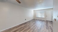 Located at 6526 208th St SW in Lynnwood, Washington, this efficiently designed single-floor unit offers a thoughtful layout that maximizes every square foot. The open living area is finished with warm wood-look vinyl plank flooring that flows throughout the entire space, complemented by neutral-toned walls and a textured ceiling. A ceiling fan provides added comfort, while a window with horizontal blinds allows natural light to fill the room. A closet with double panel doors provides convenient storage directly off the living area.

The kitchen is well-appointed with white shaker-style cabinetry, granite-look countertops, and a full suite of stainless steel appliances including a refrigerator, range, microwave, and dishwasher. A skylight panel above the kitchen adds brightness to the workspace, and the seamless connection to the living area gives the kitchen an open, airy feel.

The bathroom is clean and functional, featuring a tub/shower combo with a curved curtain rod, a window for natural ventilation, and wood-look flooring consistent with the rest of the unit. Grab bars add an element of accessibility. The overall aesthetic is modern and move-in ready, with a cohesive, neutral palette throughout.