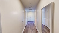 Located at 699 N Broad St in Philadelphia's vibrant Northern Liberties neighborhood, this well-appointed 4-bedroom, 2-bathroom unit offers a thoughtfully designed single-floor layout. The open-concept living area features hardwood-style flooring, warm neutral tones, and a striking arched window that frames sweeping city views and fills the space with natural light. A second arched window offers charming views of the surrounding historic brick architecture. The kitchen is equipped with warm-toned cabinetry, granite countertops, a breakfast bar, stainless steel appliances including a refrigerator, range, and microwave, plus pendant lighting and an additional arched window for natural light. Two well-lit hallways connect the four bedrooms, each featuring plush carpeting and generous double closet storage — with seven closets total throughout the unit. The primary bedroom provides a comfortable, private retreat. Both bathrooms are clean and functional, with one featuring a tub-shower combination lined in classic white subway tile. A dedicated laundry area adds everyday convenience. The space balances modern finishes with architectural character, making it a practical and attractive option in central Philadelphia.