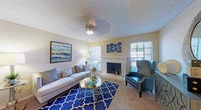 Located at 15889 Preston in Dallas, Texas, this single-floor residence offers a well-organized layout with distinct living, dining, kitchen, bedroom, and bathroom spaces. The living room serves as the heart of the home, showcasing a classic brick fireplace flanked by windows that invite natural light. Ceiling fans are present throughout, and the textured ceilings add a traditional touch. Soft carpeting flows through the main living and sleeping areas, complementing the warm, neutral color palette.

The dining area is a cozy, defined space featuring a pendant light overhead and a window for additional brightness. Adjacent to it, the kitchen is equipped with light wood cabinetry, dark granite-style countertops, black appliances including a range, dishwasher, refrigerator, and microwave, as well as hardwood-style flooring that adds warmth and practicality.

The bedroom is generously sized with plush carpeting, a ceiling fan, and a sliding glass door that opens directly to a private patio — an ideal retreat with outdoor seating. A walk-in closet is also accessible from the bedroom. The full bathroom features a single vanity with dark countertops, ample cabinet storage, hardwood-style flooring, and a tub-shower combination.