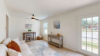 Located at 5101 Orchard Rd in Pascagoula, Mississippi, this two-story home offers a thoughtfully organized layout with 3 bedrooms, 2 bathrooms, and a coastal-inspired aesthetic throughout. The main floor features a welcoming living room adorned with light tile flooring, a ceiling fan, and natural light streaming through windows dressed with blinds. French doors open outward, extending the sense of space and providing outdoor views. The kitchen is efficiently designed with crisp white cabinetry, matte black hardware, a stainless steel sink, clean countertops, and open floating shelves for added character and storage. Both floors are connected by a staircase and served by hallways that ensure smooth flow between rooms. The bedrooms are bright and serene, featuring light wood-style flooring, large windows that invite natural light, and a clean, neutral palette. The primary bedroom offers a comfortable and restful atmosphere with ample space. The bathrooms are finished with tile flooring, white vanities, and a tub-shower combination. A dedicated closet adds practical storage. The home's coastal décor, consistent use of light tones, and natural light create a calm and inviting ambiance throughout.