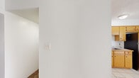 Located at 10308 Blackwood Ave in El Paso, Texas, this single-story home offers a practical and well-organized layout across four bedrooms and three full bathrooms. The interior features a consistent design palette of white walls and neutral tones throughout, creating a clean and airy atmosphere.

The bedrooms are carpeted and generously proportioned, with the primary bedroom providing a notably spacious retreat complemented by a walk-in closet fitted with built-in shelving rods for ample storage. Additional bedrooms are comfortably sized and include ceiling fans with light fixtures and windows that allow natural light to filter in.

The kitchen is equipped with warm-toned wood cabinetry, tile countertops, a double stainless steel sink, a dishwasher, and a stainless steel refrigerator, all set over light tile flooring that extends into the adjacent dining area. The open connection between the kitchen and dining room supports a functional flow for daily living.

Each bathroom features a tub-shower combination with classic white subway tile surrounds and chrome fixtures, maintaining a consistent, clean aesthetic. Three hallways connect the rooms efficiently throughout the home. With two dedicated closets, central HVAC venting, and durable flooring choices throughout, this home is designed for comfortable, straightforward living.