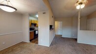 Located at 5900 Old Hickory Blvd in Nashville, Tennessee, this single-floor unit offers a practical and well-organized layout throughout. The open living and dining area is finished with wall-to-wall carpet and features a ceiling light fixture, with a sliding glass door that brings in natural light and provides access to an outdoor area. A textured ceiling is consistent throughout the unit, adding a classic residential character.

The galley-style kitchen is efficiently designed with warm oak cabinetry, granite-style countertops, and wood-look flooring. Black appliances, including a refrigerator, electric range, and dishwasher, are neatly integrated into the layout. A pass-through cutout connects the kitchen to the adjacent living space, enhancing the sense of openness.

The bedrooms are generously proportioned, each featuring plush carpet, neutral wall tones, and ceiling light fixtures. One bedroom includes a vaulted ceiling detail, adding architectural interest, while another offers direct access to a closet and the bathroom.

The bathroom is well-appointed with a wood-look tile floor, a vanity topped with granite-style countertops, warm wood cabinetry, and a shower-tub combination. The unit's warm, neutral color palette and functional design make it a comfortable and move-in-ready residence in the Nashville area.