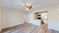 Located at 890 W Loveland Ave in Loveland, Ohio, this single-floor residence offers three bedrooms, one bathroom, and a practical, well-organized layout. The open-concept living area features light wood-look flooring and a ceiling fan, flowing seamlessly into the kitchen. The kitchen is equipped with white cabinetry, granite countertops, a subway tile backsplash, and a full suite of stainless steel appliances including a range, microwave, and refrigerator, with a peninsula providing additional counter space. A sliding glass door in one room opens to a private balcony, bringing in natural light and outdoor views of the surrounding greenery. The bedrooms include a generously sized primary bedroom with a ceiling fan and closet, while the additional bedrooms feature plush carpeting and bright windows. Four closets throughout the unit provide ample storage. The bathroom is finished with clean white subway tile surrounding a full soaking tub and shower combo with brushed gold fixtures. An in-unit laundry area adds everyday convenience. Neutral tones and consistent finishes throughout give the space a cohesive, move-in-ready feel.