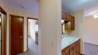 Located at 719 N Court St, Unit 316 in Rockford, Illinois, this one-bedroom, one-bathroom unit offers a functional and well-organized single-floor layout. The living room is generously sized, featuring warm beige walls, plush carpeting, and a large window that allows natural light to fill the space. A baseboard heating system and wall-mounted air conditioning unit provide year-round climate control. The bedroom is a comfortable retreat with the same neutral color palette and carpeted flooring, highlighted by a wide window with exterior views and a dedicated closet with louvered bi-fold doors for ample storage. The bathroom is clean and straightforward, featuring a tiled tub-shower combination with chrome fixtures and a classic white finish throughout. The kitchen area is efficiently arranged with wood-toned cabinetry and standard appliances, connecting seamlessly to the rest of the unit. Consistent warm beige tones, white trim, and carpet throughout the unit create a cohesive and inviting atmosphere. The layout makes practical use of every area, providing clear separation between the living, sleeping, and utility spaces.