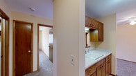 Located at 719 N Court St, Unit 316 in Rockford, Illinois, this one-bedroom, one-bathroom unit offers a functional and well-organized single-floor layout. The living room is generously sized, featuring warm beige walls, plush carpeting, and a large window that allows natural light to fill the space. A baseboard heating system and wall-mounted air conditioning unit provide year-round climate control. The bedroom is a comfortable retreat with the same neutral color palette and carpeted flooring, highlighted by a wide window with exterior views and a dedicated closet with louvered bi-fold doors for ample storage. The bathroom is clean and straightforward, featuring a tiled tub-shower combination with chrome fixtures and a classic white finish throughout. The kitchen area is efficiently arranged with wood-toned cabinetry and standard appliances, connecting seamlessly to the rest of the unit. Consistent warm beige tones, white trim, and carpet throughout the unit create a cohesive and inviting atmosphere. The layout makes practical use of every area, providing clear separation between the living, sleeping, and utility spaces.