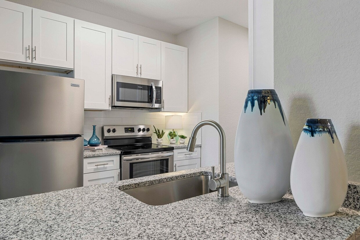 Upgraded Apartments - Luxury vinyl plank flooring in all kitchens and baths. In select living and dining rooms. - Reserve At Beachline Apartments