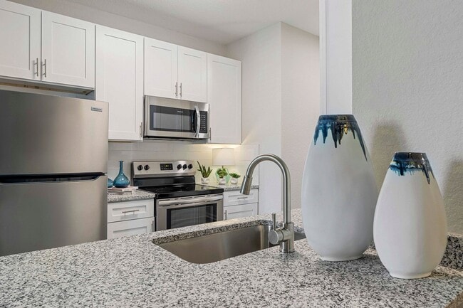 Upgraded Apartments - Luxury vinyl plank flooring in all kitchens and baths. In select living and dining rooms. - Reserve At Beachline Apartments