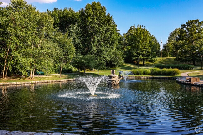 The pond has a fountain in the center at Lewis Park in University City, Missouri.