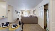 Located at 2000 Village Bluff Pl in Raleigh, NC, this single-floor residence from Village Green is designed to deliver comfortable, functional living. The open-concept layout connects the living and dining areas seamlessly, with plush carpeting underfoot and ceiling fans overhead providing a welcoming atmosphere. The living room offers generous space for lounging, with natural light filtering in through sliding glass doors that brighten the entire area.

The kitchen features hardwood-style flooring, ample cabinetry, light countertops, a dishwasher, and a full range — offering everything needed for everyday meal preparation. Adjacent to the kitchen, the dining area accommodates a full table setting, ideal for shared meals.

The bedrooms are well-proportioned and carpeted, each offering ceiling fans or overhead lighting, large windows with natural light, and open closets with built-in hanging and shelving space. The rooms provide a versatile layout suitable for both sleeping and studying, with dedicated desk areas visible in several rooms.

The bathrooms are cleanly finished with vanity countertops, large mirrors, and shower/tub combinations with tile surrounds and wood-style flooring. Every element of this residence reflects a practical and comfortable design tailored for everyday living in the heart of Raleigh.