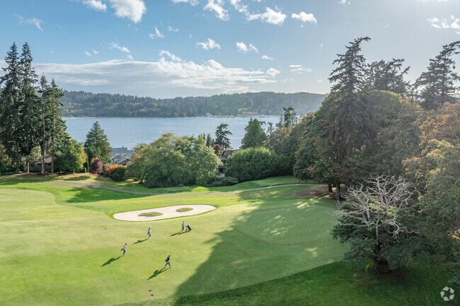 Golfers enjoy an evening game on the lush Wing Point Golf and Country Club in Bainbridge Island.