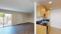This well-appointed 2-bedroom, 2-bathroom single-story home in Lakewood, California offers a practical and comfortable layout across a thoughtfully organized floor plan. Hardwood-style flooring flows consistently throughout the living areas and bedrooms, lending a cohesive and clean aesthetic to the entire home.

The living room is bright and welcoming, featuring crown molding, a ceiling fan, and a sliding glass door that opens to an outdoor area, allowing natural light to fill the space. A wall-mounted A/C unit provides convenient climate control.

The galley-style kitchen is efficiently designed with warm maple cabinetry, dark granite countertops, recessed lighting, a gas range, built-in microwave, dishwasher, and a stainless steel double sink — offering ample functionality for everyday cooking. A ceiling fan and window keep the kitchen comfortable and well-lit.

The generously sized primary bedroom includes a mirrored sliding-door closet with built-in shelving, offering excellent storage. Both bathrooms are clean and functional, featuring tub-shower combinations.

A central hallway connects the bedrooms and bathrooms, providing a logical flow throughout the home. Crown molding and textured ceilings are consistent architectural details found across the space, adding a touch of classic character to this Lakewood residence.