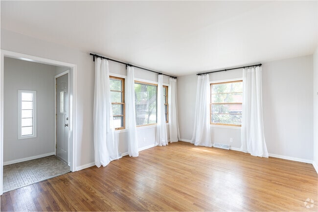 Freshly painted living room with original hardwood floors and tons of natural light! - 3118 28th Ave S