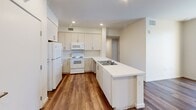 Located at 2530 Westminster Ave in Santa Ana, California, this single-story, 4-bedroom, 2-bathroom home offers a well-organized and functional layout. Warm wood-look flooring runs consistently throughout the space, lending a cohesive and inviting feel to every room.

The kitchen serves as a central highlight, featuring cream-toned cabinetry that extends to the ceiling for ample storage, white appliances including a refrigerator, electric range, and microwave, and a peninsula island with a clean white countertop and double sink. Recessed lighting illuminates the space efficiently.

Four bedrooms provide comfortable accommodations, each finished with the same warm flooring and neutral white walls. The primary bedroom includes mirrored sliding closet doors that reflect natural light, enhancing the sense of space. Additional bedrooms offer access to natural light through windows dressed with vertical blinds.

Both bathrooms are clean and functional, each equipped with a tub/shower combination with tiled surround, white vanity with ample counter space, and a well-lit mirror. The hallway connects the rooms efficiently, supporting a practical flow throughout the home.

Overall, the space presents a bright, neutral palette with a modern, no-frills aesthetic — well-suited for comfortable everyday living.