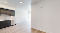 Located at 4555 30th Street in San Diego's vibrant Normal Heights neighborhood, this modern two-bedroom, one-bathroom unit offers a thoughtfully designed single-floor layout with clean lines and contemporary finishes throughout. Light wood-tone flooring flows seamlessly across the entire space, complementing the bright white walls and recessed lighting that create a fresh, open atmosphere.

The kitchen is a standout feature, showcasing sleek dark cabinetry, white countertops, a classic subway tile backsplash, and a full suite of stainless steel appliances including a refrigerator, range, microwave, and dishwasher. The kitchen opens directly to the living area, which is equipped with a ceiling fan and benefits from natural light.

The bedrooms are well-appointed with light-filled windows offering neighborhood views. A stylish sliding barn door leads into one bedroom, which also features a closet with hanging rod storage. The bathroom is clean and modern, featuring a tiled tub-shower combo with brushed nickel fixtures and a built-in niche for added convenience.

Two hallways connect the rooms efficiently, and the overall layout makes practical use of the available space. The unit's modern design, quality finishes, and prime San Diego location make it a well-rounded residential offering.