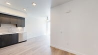 Located at 4555 30th Street in San Diego's vibrant Normal Heights neighborhood, this modern two-bedroom, one-bathroom unit offers a thoughtfully designed single-floor layout with clean lines and contemporary finishes throughout. Light wood-tone flooring flows seamlessly across the entire space, complementing the bright white walls and recessed lighting that create a fresh, open atmosphere.

The kitchen is a standout feature, showcasing sleek dark cabinetry, white countertops, a classic subway tile backsplash, and a full suite of stainless steel appliances including a refrigerator, range, microwave, and dishwasher. The kitchen opens directly to the living area, which is equipped with a ceiling fan and benefits from natural light.

The bedrooms are well-appointed with light-filled windows offering neighborhood views. A stylish sliding barn door leads into one bedroom, which also features a closet with hanging rod storage. The bathroom is clean and modern, featuring a tiled tub-shower combo with brushed nickel fixtures and a built-in niche for added convenience.

Two hallways connect the rooms efficiently, and the overall layout makes practical use of the available space. The unit's modern design, quality finishes, and prime San Diego location make it a well-rounded residential offering.
