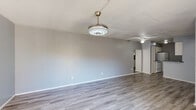Located on Kemp Blvd in Wichita Falls, TX, this single-story 2-bedroom, 2-bathroom home offers a functional and comfortable layout across a well-utilized floor plan. The spacious living room is a standout feature, finished with light-toned wood-look flooring, soft gray walls, and a stylish modern ceiling fan with integrated lighting. A sliding glass door floods the room with natural light and provides direct access to an outdoor patio area. The galley-style kitchen features dark granite-look countertops, white cabinetry, a double-basin stainless steel sink, and white appliances including a range and refrigerator, all complemented by wood-look flooring. Both bedrooms are carpeted and include ceiling fans. The primary bedroom is generously sized with its own dedicated closet, while the second bedroom benefits from a large window that brings in ample natural light. Each bedroom is served by its own bathroom, both featuring tub-shower combinations with built-in shelving. Two closets provide practical storage throughout the home. A hallway connects the private areas of the home, creating a clear separation between living and sleeping spaces. The overall aesthetic is clean, neutral, and move-in ready.