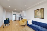Located at 3309 Liberty Ave in North Bergen, NJ, this well-appointed 2-bedroom, 2-bathroom residence offers a thoughtfully designed single-floor layout with a clean, modern aesthetic throughout. Light hardwood flooring runs continuously across the living spaces, complementing the crisp white walls and recessed lighting that create a bright, airy atmosphere.

The open-concept living, dining, and kitchen area forms the heart of the home. The kitchen is outfitted with high-gloss white cabinetry extending to the ceiling, white quartz countertops, a seamless tile backsplash, and a full suite of stainless steel appliances including a gas range, over-the-range microwave, and refrigerator. The adjoining dining and living areas provide comfortable, flexible space for daily living and entertaining.

The spacious primary bedroom offers a generous walk-in closet with built-in shelving and hanging rods. A second bedroom and additional closets — four in total — provide ample storage throughout the residence. A dedicated laundry area adds everyday convenience.

Both bathrooms are finished in clean white tile, with the full bath featuring a tiled walk-in shower with a glass enclosure and large-format floor tiles. The overall design is cohesive, modern, and move-in ready.