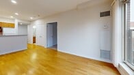 Located at 20 York St in the heart of Ottawa, this 2-bedroom, 1-bathroom residence offers a well-organized single-floor layout designed for comfortable urban living. The entryway features warm hardwood flooring and recessed lighting, providing a clean and welcoming transition into the home. The combined kitchen and living room area serves as the central hub of the space. The kitchen is outfitted with warm-toned wood cabinetry, granite-look countertops, a double sink, and white appliances including a dishwasher, electric range, and refrigerator, all set on hardwood floors. The living area flows naturally from the kitchen and is bathed in natural light from large sliding glass doors that open to a balcony, offering views of Ottawa's surrounding urban architecture. The primary bedroom is a generously sized retreat with large multi-pane windows that frame city views and allow abundant natural light, finished with soft carpet flooring. The second bedroom is equally comfortable, also carpeted with neutral tones. The bathroom features tile flooring, a full soaker tub with a tile surround, and a handheld showerhead. A hallway connects all rooms efficiently, completing this practical and well-appointed urban residence.
