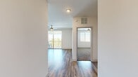 Located at 250 E Ray Rd in Chandler, Arizona, this well-appointed one-bedroom, one-bathroom residence offers a thoughtfully designed single-level layout. The open living area features wood-style flooring, crisp white walls, and a ceiling fan, with a sliding glass door leading to a private balcony that brings in abundant natural light and outdoor views of the surrounding neighborhood.

The kitchen is a standout feature, showcasing dark espresso cabinetry paired with granite countertops, a classic subway tile backsplash, and a full suite of stainless steel appliances including a refrigerator, range, built-in microwave, and dishwasher. Warm wood-style flooring continues throughout this space, adding to the modern aesthetic.

The bedroom is a comfortable, carpeted retreat equipped with a ceiling fan and a window with blinds that allows for natural light and outdoor views. A dedicated closet provides ample storage.

The bathroom is finished with wood-style flooring and features a glass-enclosed shower. A notable convenience is the inclusion of an in-unit stacked washer and dryer, seamlessly integrated into the bathroom area. A hallway connects the rooms, contributing to an efficient and functional floor plan ideal for comfortable everyday living.
