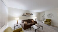This two-story, two-bedroom, one-bathroom home in Maple Shade, NJ offers a practical and comfortable layout spread across two floors. The main level features a carpeted living room with neutral walls, built-in wall shelving, and a staircase with decorative iron railings leading to the upper level. Adjacent to the living room, the dining area boasts a light blue accent wall with natural light streaming through a window fitted with blinds. The kitchen is efficiently designed with warm wood cabinetry, granite-style countertops, tile flooring, a gas range, dishwasher, and convenient access to the in-unit laundry area. Upstairs, the primary bedroom provides a comfortable retreat with plush carpet, a sliding-door closet, and soft neutral tones. The second bedroom offers similar finishes and versatile space. The full bathroom features a tiled tub-shower combo, wood-look vinyl flooring, and clean white fixtures. A notable feature of this home is its abundance of storage, with six closets distributed throughout. The overall aesthetic is clean and understated, with consistent carpet flooring on the upper level and tile in the kitchen and bath, creating a cohesive and functional living environment.