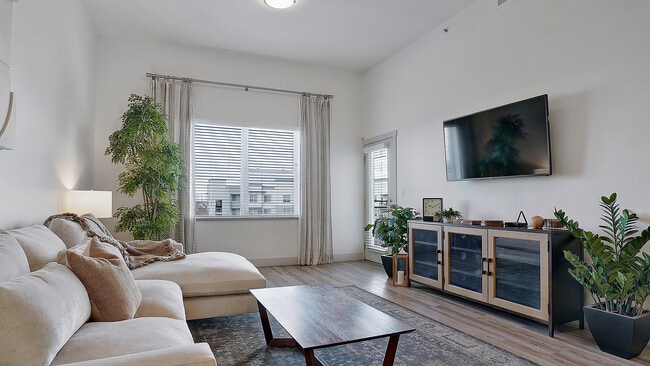 Bright living room with open space and natural light. - Parkway Lofts
