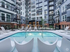 Soak, sun, and unwind in our resort-style courtyard pool, complete with in-water loungers, private seating, and a peaceful city backdrop. - Modera H Street