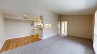 Located in Texas City, TX, this single-floor residence offers a practical and comfortable layout with 2 bedrooms and 2 bathrooms. The open living and dining area is a defining feature, with neutral-toned carpet underfoot and a vaulted ceiling that enhances the sense of space. A pass-through bar counter connects the living area to the kitchen, which is designed in a galley style with wood-look flooring, white cabinetry, light stone-patterned countertops, and a full suite of appliances including a range, refrigerator, and dishwasher. A dedicated pantry provides additional storage off the kitchen. The living area also includes a large sliding glass door dressed with vertical blinds, allowing natural light to fill the room. Both bedrooms are carpeted and equipped with ceiling fans. The spacious primary bedroom features direct access to its own bathroom and a generous walk-in closet with wrap-around shelving and hanging rods. A second full bathroom serves the additional bedroom. Throughout the residence, four closets offer substantial storage capacity. The overall design is clean and functional, with a neutral color palette that provides a versatile backdrop for any furnishing style.
