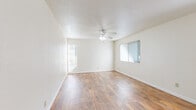 Located at 2950 Portage Bay W in Davis, CA, this one-bedroom, two-bathroom unit offers a well-organized layout across a single floor. The open living and dining area is bright and welcoming, featuring warm wood-style flooring, a ceiling fan with light fixture, textured ceilings, and multiple windows with vertical blinds that allow for ample natural light. The kitchen is efficiently designed with warm-toned wood cabinetry, light countertops, a stainless steel sink, and a full suite of appliances including a gas range, dishwasher, and refrigerator. A pass-through breakfast bar connects the kitchen to the living area, enhancing the open feel of the space. The bedroom is carpeted for comfort and features a large window that brings in natural light, along with access to a dedicated walk-in closet equipped with built-in shelving and hanging rods for generous storage. The two bathrooms include one with a tub-shower combo fitted with sliding glass doors and wood-style flooring, and a second full bath accessible from the hallway. Warm wood cabinetry and white countertops carry through the bathroom design, providing a cohesive aesthetic throughout the unit. A connecting hallway ties the layout together efficiently.