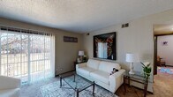 Located at 2768 S Seneca St in Wichita, Kansas, this single-floor unit offers a practical and comfortable layout spread across several distinct rooms. The living room serves as the central gathering space, featuring neutral-toned carpet, a textured ceiling, and a large sliding glass door fitted with vertical blinds that floods the room with natural light and provides direct access to an outdoor patio area. The entryway opens into this same living space, offering room for additional seating or display furniture.

The kitchen is equipped with dark cabinetry providing ample upper and lower storage, light countertops, a double-basin sink, a dishwasher, and tile flooring, giving it a clean and functional character. A dedicated dining area is situated nearby, adding to the unit's practical flow.

The primary bedroom is generously proportioned with carpet flooring, a closet, and a window that brings in natural light. Additional bedrooms also feature carpet, windows with blinds, and sufficient space for furnishings. The bathroom includes wood-look flooring, a vanity with dark cabinetry, a toilet, and a shower-tub combination. Textured ceilings are consistent throughout the unit, contributing to its cohesive interior character.