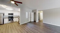 Located at 10757 Lemon Ave in Rancho Cucamonga, CA, this single-story home offers a well-designed layout with a mix of modern finishes and comfortable living spaces. The living room is a standout area, boasting soaring vaulted ceilings, a ceiling fan, rich hardwood-style flooring, and a fireplace that serves as a focal point. Sliding doors invite natural light and provide access to the outdoors, enhancing the open and airy ambiance of the space. The kitchen is thoughtfully appointed with crisp white cabinetry, stainless steel appliances including a refrigerator, range, microwave, and dishwasher, all set against light wood-style flooring. A window brings in additional natural light, making this an inviting space for cooking and entertaining. The bedrooms feature plush carpeting, neutral-toned walls, and windows with blinds that frame views of the surrounding greenery, offering a calm and restful retreat. Closet storage is conveniently provided in the bedroom area. Both bathrooms are finished with wood-style flooring, vanities with taupe countertops, large mirrors, and tub-shower combinations. The overall aesthetic throughout the home is clean and contemporary, with a neutral palette that provides a versatile backdrop for any style of décor.