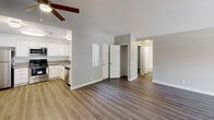 Located at 10757 Lemon Ave in Rancho Cucamonga, CA, this single-story home offers a well-designed layout with a mix of modern finishes and comfortable living spaces. The living room is a standout area, boasting soaring vaulted ceilings, a ceiling fan, rich hardwood-style flooring, and a fireplace that serves as a focal point. Sliding doors invite natural light and provide access to the outdoors, enhancing the open and airy ambiance of the space. The kitchen is thoughtfully appointed with crisp white cabinetry, stainless steel appliances including a refrigerator, range, microwave, and dishwasher, all set against light wood-style flooring. A window brings in additional natural light, making this an inviting space for cooking and entertaining. The bedrooms feature plush carpeting, neutral-toned walls, and windows with blinds that frame views of the surrounding greenery, offering a calm and restful retreat. Closet storage is conveniently provided in the bedroom area. Both bathrooms are finished with wood-style flooring, vanities with taupe countertops, large mirrors, and tub-shower combinations. The overall aesthetic throughout the home is clean and contemporary, with a neutral palette that provides a versatile backdrop for any style of décor.