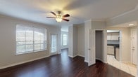 This single-floor, 3-bedroom, 2-bathroom home is thoughtfully designed to maximize comfort and functionality. The open living and dining area features rich, dark hardwood flooring, crown molding, and a ceiling fan with light fixture. Large windows with blinds allow ample natural light to fill the space, while a glass door provides direct outdoor access. The adjoining dining area benefits from an arched window that adds architectural character.

The kitchen is equipped with light wood cabinetry, dark granite-style countertops, tile flooring, and a full suite of black appliances including a refrigerator, range, built-in microwave, and dishwasher. A window above the sink brings in additional natural light.

All three bedrooms are carpeted and feature ceiling fans, arched windows, and generous closet space—including a walk-in closet in one room and a built-in shelved closet in another. The primary bedroom includes direct access to an en-suite bathroom.

Both bathrooms are finished with light tile flooring, light wood vanity cabinets, and dark granite-style countertops. The primary bath features a dual-sink vanity with a large mirror and a tub/shower combo, while the secondary bath offers a single-sink vanity and tub/shower combination. Both bathrooms include overhead cabinetry for additional storage.