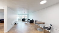 This efficiently designed 1-bedroom, 1-bathroom unit offers a thoughtful layout across a single floor, making excellent use of its compact footprint. The open living area is bright and airy, featuring warm light wood flooring, white walls, and a large window that invites natural light and provides views of the surrounding neighborhood. The living space comfortably accommodates a seating area and a dining table, creating a versatile environment for both relaxing and entertaining.

The kitchen is outfitted with stainless steel appliances — including a full-size refrigerator, gas range, and microwave — complemented by white shaker-style cabinetry and clean countertops, offering a functional and modern cooking space.

The bedroom is a well-sized private retreat, featuring the same light hardwood flooring, a window for natural light, and a built-in sliding-door closet with integrated shelving, providing ample storage. A dedicated desk area makes the room suitable for work or study as well.

The bathroom features a classic tiled tub-shower combination with distinctive mint-green wall tile, a white vanity, and hardwood flooring, lending a clean retro aesthetic. Throughout the unit, the consistent use of light wood flooring, neutral white walls, and flush-mount lighting creates a cohesive, clean, and modern atmosphere.