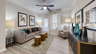 Located at 2951 Satellite Blvd in Duluth, GA, this single-floor residence offers three bedrooms and three bathrooms across a efficiently designed layout. The living room features crown molding, light wood-style flooring, and a ceiling fan, with natural light streaming through large windows dressed in elegant grommet curtains. The adjacent dining area echoes the refined aesthetic with its own crown molding, chair rail detail, and a statement pendant light overhead. The kitchen is outfitted with white cabinetry, granite-look countertops, stainless steel appliances including a range and microwave, and a stainless steel sink — all set on wood-style flooring. The primary bedroom offers a comfortable, carpeted retreat, while additional bedrooms are equally well-sized with plush carpeting and ample natural light. Closets include a spacious walk-in with wire shelving systems for organized storage. The bathrooms feature tub-shower combinations with white tile surrounds, granite-topped vanities, and wood-style flooring. A dedicated laundry area houses a full-size washer and dryer with overhead wire shelving. This residence combines practical functionality with clean, contemporary design throughout.