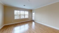Located at 100 Holling FR in Frederick, MD, this single-floor residence offers a thoughtfully designed open-concept layout that seamlessly connects the kitchen, dining, and living areas. The kitchen is a standout feature, outfitted with rich dark espresso cabinetry, granite countertops, a classic white subway tile backsplash, and a full suite of stainless steel appliances including a gas range, built-in microwave, and refrigerator. A large center island with an undermount sink and pendant lighting above serves as both a functional workspace and a natural gathering point. Light hardwood flooring flows throughout the main living area, complemented by crown molding that adds a refined architectural touch. The living space is bright and open, with large windows allowing generous natural light and access to an exterior door. The bedroom is a comfortable, well-proportioned room finished with soft carpeting and a window overlooking the outdoors. The bathroom features large-format tile flooring, a dark wood vanity with a white countertop, a well-lit mirror, and a tub-shower combination with clean white tile surround. Overall, the space presents a cohesive, modern aesthetic with warm tones and quality finishes throughout.
