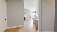 Located at 601 Press Pl in Nashville's vibrant Germantown area, this well-appointed 2-bedroom, 1-bathroom residence offers a thoughtfully designed single-floor layout. Light hardwood flooring flows throughout, complementing a neutral color palette that lends the space a clean, contemporary feel.

The open-concept kitchen and living area serves as the heart of the home. The chef-inspired kitchen features two-tone cabinetry in white and slate gray, a herringbone tile backsplash, stainless steel appliances, a wall-mounted range hood, and a large center island with quartz countertops and seating for two. Statement brass pendant lights add warmth and style overhead.

The living room is anchored by dramatic floor-to-ceiling windows with black frames, inviting an abundance of natural light and offering serene views of lush landscaped greenery and a courtyard beyond.

The generously sized primary bedroom includes its own natural light source via a large window, direct access to the full bathroom, and leads to a dedicated walk-in closet outfitted with custom built-in shelving, hanging rods, and integrated drawer storage. The second bedroom is a comfortable, quiet retreat with clean walls and ample space.

The full bathroom features an elegant glass-enclosed walk-in shower adorned with large-format marble tile and a herringbone accent wall, finished with matte black hardware for a refined, modern touch.