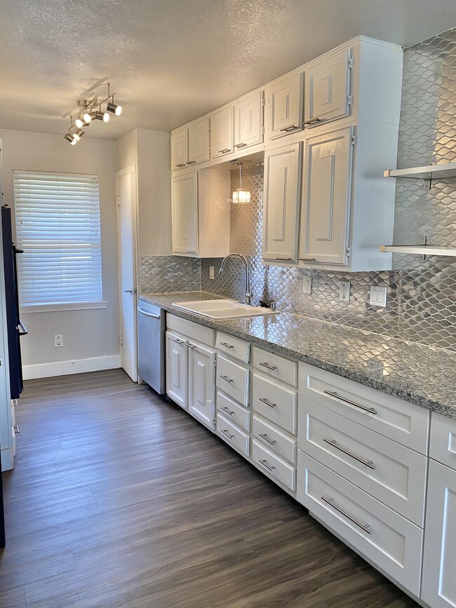 Kitchen. Designer tile and lighting. New SS range, D/W and microwave being installed - 2704 Whitson Way