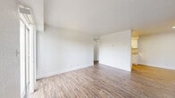 Located at 1905 S Sheridan Rd in Tulsa, Oklahoma, this one-bedroom, one-bathroom residence offers a well-organized, single-floor layout designed to maximize every square foot. Wood-look luxury vinyl flooring runs throughout, providing a cohesive and low-maintenance aesthetic across all rooms.

The combined kitchen and living area forms the heart of the unit. The galley-style kitchen is thoughtfully appointed with white shaker cabinetry, granite-look countertops, a stainless steel sink, and stainless steel appliances including a range, microwave, and refrigerator. Bright overhead lighting enhances the clean, crisp feel of the space. The adjacent living room is open and airy, with white walls and a sliding glass door that fills the room with natural light and leads directly to a private patio — ideal for outdoor relaxation.

The bedroom is a comfortable, well-proportioned retreat featuring a ceiling fan with integrated light fixture, a natural light window, and access to two closets, offering ample storage. A hallway connects the main living spaces to the bathroom, which includes a granite-top vanity with white cabinetry, a tiled shower-tub combination, and consistent wood-look flooring. The layout is completed by a hallway that ensures smooth flow between all areas of the home.