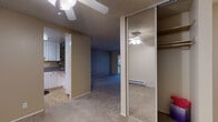 Located at 998 Meridian Ave in the heart of San Jose, CA, this single-floor residence offers a practical and comfortable layout designed for everyday living. The living area is finished with wall-to-wall carpeting and features a ceiling fan, a textured ceiling, and a sliding glass door that opens to a private balcony with views of mature surrounding trees, allowing natural light to fill the space. An adjacent room, also carpeted and generously sized, benefits from a large sliding window that frames pleasant greenery outside, complemented by a baseboard heating unit. The kitchen is efficiently designed with white cabinetry, granite-style countertops, a tile backsplash, and white appliances including a range and refrigerator, with light wood-style flooring adding warmth. The bedroom area includes a walk-in closet with built-in shelving, as well as an additional mirrored sliding-door closet for ample storage. The bathroom is clean and well-finished, featuring a granite-topped vanity with white cabinetry, light wood-style flooring, and a glass-enclosed shower stall. Throughout the residence, neutral tones and functional finishes create a cohesive, livable atmosphere.