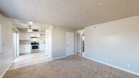 Located at 315 W Alamos Ave in Clovis, CA, this 2-bedroom, 1-bathroom single-floor unit offers a well-organized and functional layout. The open-concept living and dining area features plush wall-to-wall carpeting and a textured ceiling, creating a cozy yet clean aesthetic. A ceiling fan keeps the space comfortable year-round. The kitchen is outfitted with crisp white shaker cabinets, light stone-look countertops, stainless steel appliances including an electric range, dishwasher, and refrigerator, and durable light wood-look vinyl flooring. A pantry provides added storage convenience. Both bedrooms are carpeted and feature textured ceilings and ceiling fans, with the primary bedroom offering a generous footprint. Multiple closets throughout the unit ensure ample storage. The full bathroom includes a tub/shower combo, a vanity with a light stone countertop, and wood-look vinyl flooring. A hallway connects the main living spaces, and two utility rooms add practicality. A private balcony extends the living space outdoors. The unit's neutral color palette and clean finishes provide a move-in-ready feel throughout.