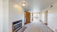 Located at 4000 Hyde Park Ave in Columbia, Missouri, this single-floor residence offers a well-organized and functional layout designed for comfortable everyday living. The spacious living room serves as the heart of the home, featuring plush wall-to-wall carpeting, a textured ceiling, and a classic fireplace with a brick hearth and gold-trimmed glass doors — a standout focal point that adds warmth and character to the space. A sliding glass door at the far end of the living area provides direct access to an outdoor patio and fills the room with natural light. The kitchen is efficiently designed with warm oak cabinetry, dark granite-style countertops, a double-basin sink, and wood-look flooring, complemented by a window that brings in additional daylight. In-unit laundry is conveniently tucked nearby. The bedrooms are carpeted and bright, each featuring windows with blinds and ample closet space, including sliding-door wardrobes for organized storage. The bathroom is clean and straightforward, equipped with a full tub-shower combo, wood-look flooring, and a vanity. Warm wood trim and neutral tones throughout create a cohesive, inviting atmosphere across the entire residence.