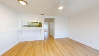 Located at 5009 S West Shore Blvd in Tampa, FL, this one-bedroom, one-bathroom unit offers a thoughtfully designed single-floor layout that maximizes every square foot. Light hardwood flooring runs consistently throughout the space, creating a warm, cohesive aesthetic from room to room.

The open living area is bright and airy, benefiting from natural light and a ceiling fan overhead. It connects seamlessly to the kitchen via a pass-through counter with bar-top seating, making the space feel open and connected. The kitchen features white cabinetry, a stainless steel refrigerator, and a practical galley-style layout.

The bedroom is a well-proportioned, private retreat with its own ceiling fan, a window with blinds that allows natural light while maintaining privacy, and two closets offering generous storage. The clean white walls and light flooring keep the room feeling fresh and spacious.

The bathroom includes a full tub-shower combination with brushed nickel fixtures set against clean white tile, maintaining the unit's consistent, clean aesthetic. A utility room rounds out the layout, providing additional functional space.

Throughout the unit, white walls, light hardwood floors, and ceiling fans in every room contribute to a bright, clean, and comfortable atmosphere well-suited to the warm Tampa climate.