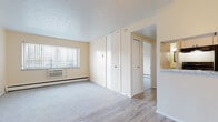 Located on Detroit Avenue in Lakewood, Ohio, this single-floor unit offers a practical and comfortable layout with a clean, neutral aesthetic throughout. The living area combines plush carpeting with wood-look vinyl flooring, creating a warm and inviting atmosphere. Natural light streams in through vertical-blind-covered windows, and a ceiling fan adds both style and airflow to the space. Baseboard heating runs throughout, ensuring year-round comfort. Built-in closets provide generous storage directly off the living area.

The galley-style kitchen is efficiently designed, featuring white cabinetry, a stainless steel sink with a marble-look countertop, a dishwasher, and black appliances including a refrigerator and electric range. Wood-look flooring ties the kitchen seamlessly to the adjacent living space.

The bedroom is a peaceful, carpeted retreat with a large window that fills the room with natural light and baseboard heating along the perimeter walls. The full bathroom is thoughtfully appointed with tile flooring, a dark espresso vanity with a stone-look countertop, a framed mirror cabinet, and a full tub-shower surround. The overall palette of warm beige tones and white trim lends the unit a bright, clean, and move-in-ready feel.