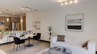 Located in the vibrant Larchmont/East Hollywood neighborhood of Los Angeles, this single-floor residence at 525 N Wilton Place offers a sleek, modern aesthetic defined by clean lines, neutral tones, and thoughtful design throughout. The open-concept living area is anchored by polished concrete floors and crisp white walls, creating a bright and airy atmosphere. Track lighting illuminates both the dining and living zones, while a large sliding glass door floods the space with natural light and opens directly to a private outdoor patio. The kitchen is outfitted with warm wood-grain cabinetry extending to the ceiling, quartz countertops, a textured tile backsplash, and stainless steel appliances including a gas range, built-in microwave, and French door refrigerator. A generous kitchen island with a white countertop provides additional prep and casual dining space. The bedroom is comfortably sized, featuring polished concrete floors, ample natural light, and a sliding mirrored closet. The bathroom maintains the home's modern sensibility with a wood-toned vanity, backlit mirror, and polished concrete floors. Overall, the unit presents a cohesive, contemporary living experience well-suited to the dynamic Los Angeles lifestyle.