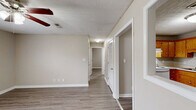 Located at 160 Stateline Rd in Clarksville, Tennessee, this single-story 2-bedroom, 1-bathroom home offers a practical and comfortable layout. The interior is finished with wood-look luxury vinyl plank flooring throughout, complemented by neutral taupe-toned walls and white trim that create a clean, cohesive aesthetic across every room.

The kitchen is equipped with warm oak cabinetry offering generous storage, white coil electric range, a stainless steel dishwasher, and a double-basin sink beneath a textured ceiling — a functional space well-suited for everyday cooking.

The primary bedroom is a well-proportioned room featuring a ceiling fan with light fixture and a window with blinds that allows natural light to filter in. A secondary bedroom provides additional flexible living space, also with natural light and neutral finishes. One bedroom includes a double-door closet, offering ample storage.

The full bathroom includes a tub/shower combination, toilet, and vanity, finished with consistent light-toned flooring that carries through from the rest of the home. A dedicated laundry area with a stacked washer and dryer unit adds everyday convenience directly within the home.

The textured ceilings and consistent use of neutral tones throughout lend the home a tidy, move-in-ready feel suitable for comfortable single-floor living.