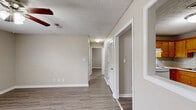 Located at 160 Stateline Rd in Clarksville, Tennessee, this single-story 2-bedroom, 1-bathroom home offers a practical and comfortable layout. The interior is finished with wood-look luxury vinyl plank flooring throughout, complemented by neutral taupe-toned walls and white trim that create a clean, cohesive aesthetic across every room.

The kitchen is equipped with warm oak cabinetry offering generous storage, white coil electric range, a stainless steel dishwasher, and a double-basin sink beneath a textured ceiling — a functional space well-suited for everyday cooking.

The primary bedroom is a well-proportioned room featuring a ceiling fan with light fixture and a window with blinds that allows natural light to filter in. A secondary bedroom provides additional flexible living space, also with natural light and neutral finishes. One bedroom includes a double-door closet, offering ample storage.

The full bathroom includes a tub/shower combination, toilet, and vanity, finished with consistent light-toned flooring that carries through from the rest of the home. A dedicated laundry area with a stacked washer and dryer unit adds everyday convenience directly within the home.

The textured ceilings and consistent use of neutral tones throughout lend the home a tidy, move-in-ready feel suitable for comfortable single-floor living.