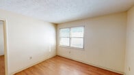 Located at 300 Charles G Stephenson Dr in Winchester, Kentucky, this one-bedroom, one-bathroom unit offers a practical and efficient single-floor layout. Warm hardwood-style flooring runs throughout the main living areas, lending a cohesive and clean aesthetic to the space. The living room provides an open, versatile area that flows conveniently toward the kitchen, which features wood-toned cabinetry, a gas range, and a full-size refrigerator — offering all the essentials for everyday cooking. Natural light filters in through windows fitted with blinds in both the living area and the bedroom, keeping the space bright and welcoming. The bedroom is a comfortable, well-proportioned retreat with a textured ceiling and easy access to multiple closets — a standout feature of this unit, with five closets total providing generous storage throughout. The bathroom includes a tiled tub-and-shower combination, stone-look tile flooring, and accessibility-friendly grab bars for added safety and convenience. Neutral wall tones and textured ceilings are consistent throughout, creating a simple, move-in-ready environment. The entrance provides a clear transition into the living space, making the overall flow of the unit intuitive and functional.