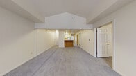 Located at 4531 Gull Prairie Pl in Kalamazoo, Michigan, this single-floor residence offers a thoughtfully arranged layout with a clean, neutral aesthetic throughout. The open-concept living and dining area is a standout feature, highlighted by a striking vaulted ceiling that adds a sense of volume and airiness to the space. Soft wall-to-wall carpeting runs through the main living area, contributing to a warm and comfortable atmosphere.

The kitchen is positioned centrally and features a wood-toned breakfast bar peninsula, white cabinetry with ample storage, light countertops, and a full suite of appliances including a gas range and dishwasher. Tile flooring in the kitchen and utility areas provides a durable, easy-to-maintain surface.

The bedrooms are generously sized, each carpeted and finished with neutral walls. One bedroom benefits from a pair of windows that allow natural light and neighborhood views, while a second bedroom features its own window overlooking tree-lined surroundings.

Two bathrooms serve the home: one includes a full soaking tub and shower combination, while the other offers a standalone walk-in shower stall with a vanity and mirror. A dedicated laundry room with side-by-side washer and dryer adds significant everyday convenience. Overall, the space presents a functional and well-organized floor plan suitable for comfortable single-floor living.